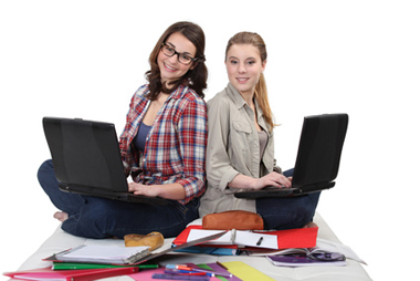 Two female students with laptops