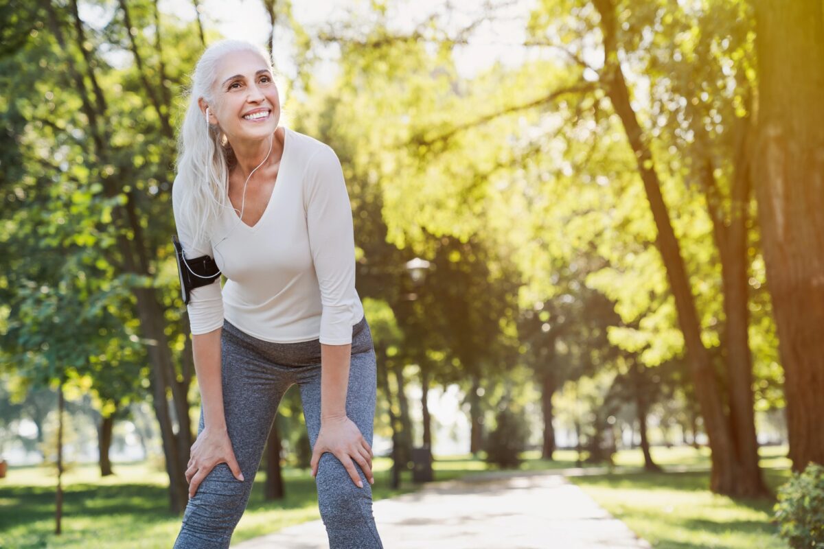 femme mure souriante au repos après course à pied